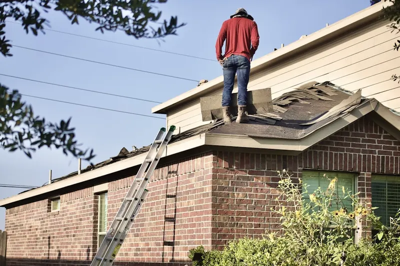 Professional roofer working on a residential roof in Nicollet Island - East Bank